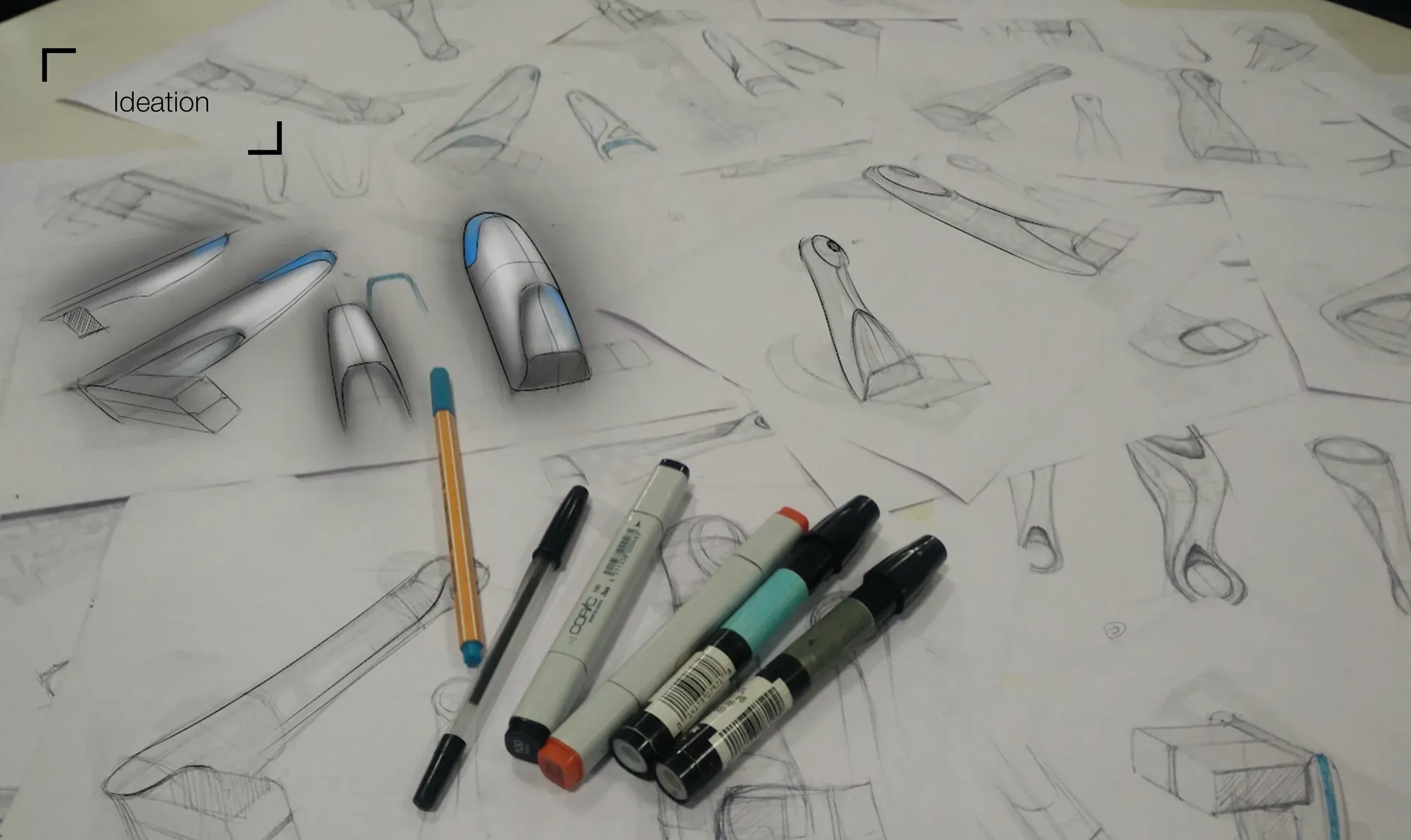 Pencil and marker sketches of robot arm forms on paper